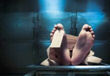 Corpse on a morgue table with toe tag