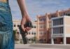 Person holding a handgun near a school building