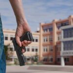 Teen Killer’s Chilling Two-Stop Rampage Person holding a handgun near a school building