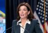 woman speaking at a podium with microphones