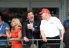 Shock Ultimatum: Tucker Demands Trump Ousted group of people on a balcony at a golf event