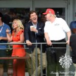 group of people on a balcony at a golf event