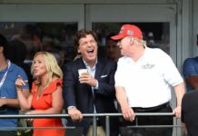 group of people on a balcony at a golf event