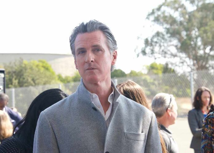 man in gray coat at an outdoor event