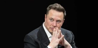 man in a suit with hands clasped thoughtfully