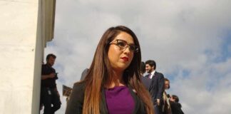 Woman in business attire walking outdoors