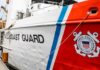 US Coast Guard ship hull with emblem and red stripe