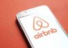 Hidden Bed Cams? Airbnb Scrambles Airbnb logo on smartphone screen