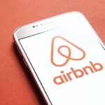 Airbnb logo on smartphone screen