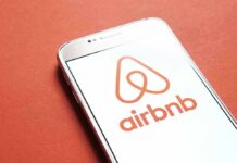 Airbnb logo on smartphone screen