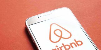 Airbnb logo on smartphone screen