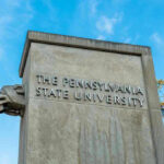 The Pennsylvania State University stone pillar with lion sculpture.