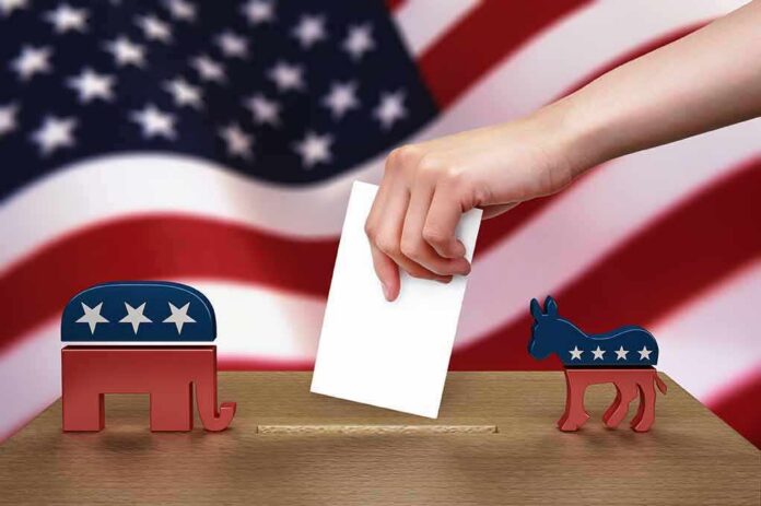 Hand casting ballot between Republican elephant and Democratic donkey