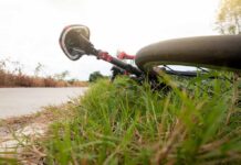 Bizarre Streaker Haunts Jersey Greenways Road bicycle lying on grass beside a rural path
