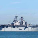 Aircraft carrier sailing on calm blue water