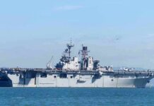 Aircraft carrier sailing on calm blue water