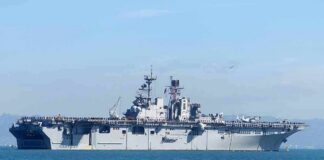 Aircraft carrier sailing on calm blue water