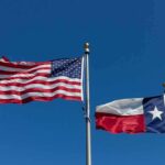 American and Texas flags waving on flagpoles