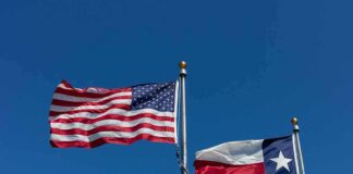 American and Texas flags waving on flagpoles