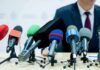 Rhetoric Sparks Violence? DHS Warning Ignites microphones clustered on a table at a press conference