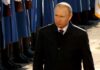 Vladimir Putin walking past a guard of honor