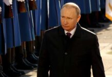 Congress Goes Nuclear – War Cash Squeeze Vladimir Putin walking past a guard of honor