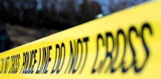 Yellow police tape stretched across an outdoor scene