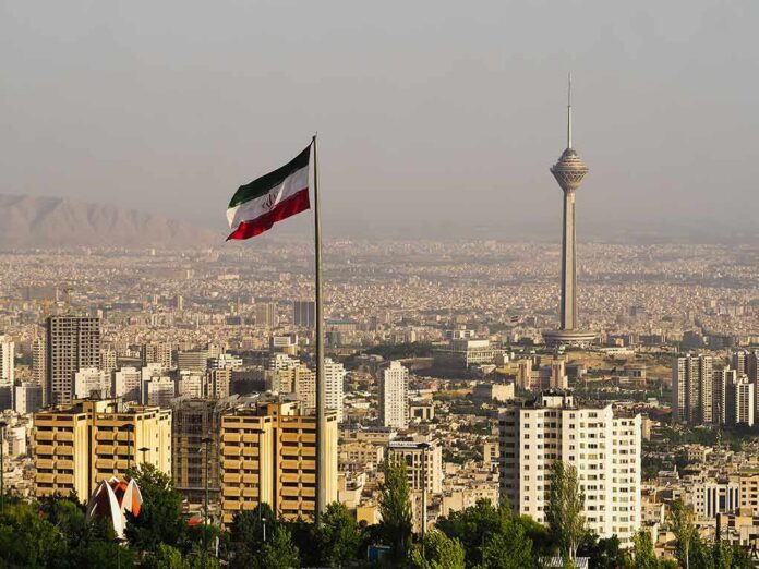Iranian flag over Tehran skyline with Milad Tower