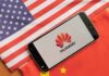 Smartphone displaying Huawei logo on U.S. and China flags