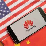 Huawei RICO Shock: ‘Culture Of Crime’ Exposed Smartphone displaying Huawei logo on U.S. and China flags
