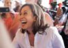 smiling woman in a crowd