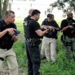 law enforcement officers conducting a search in a wooded area