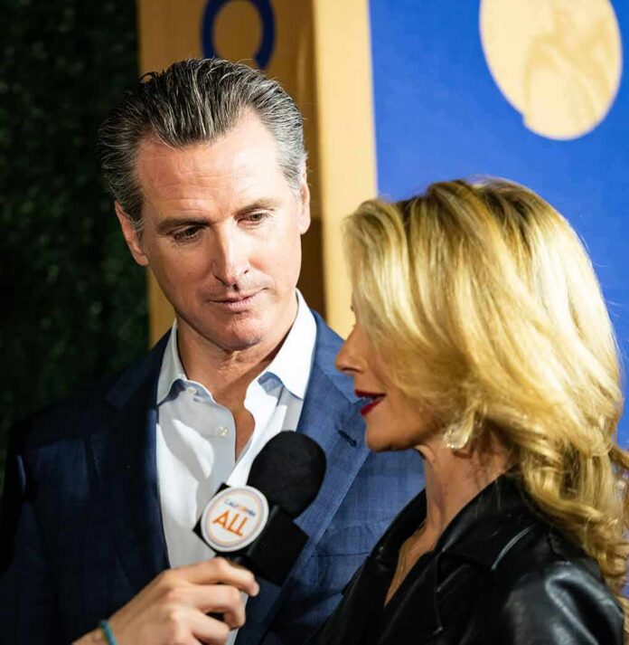 man in suit listening as woman speaks into a microphone