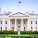 The White House facade with fountain and flag