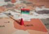 Armed Guards Choke Libya Pipeline Libyan flag pin on a map of Libya