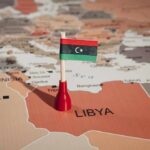 Armed Guards Choke Libya Pipeline Libyan flag pin on a map of Libya