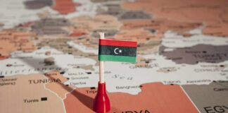 Libyan flag pin on a map of Libya