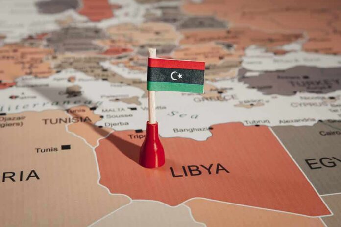 Libyan flag pin on a map of Libya