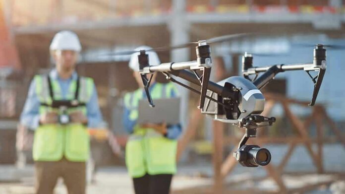 shutterstock_1712804086 drone with camera flying at construction site