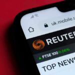 Smartphone displaying Reuters mobile website