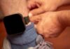 Person fastening an ankle monitor on a leg
