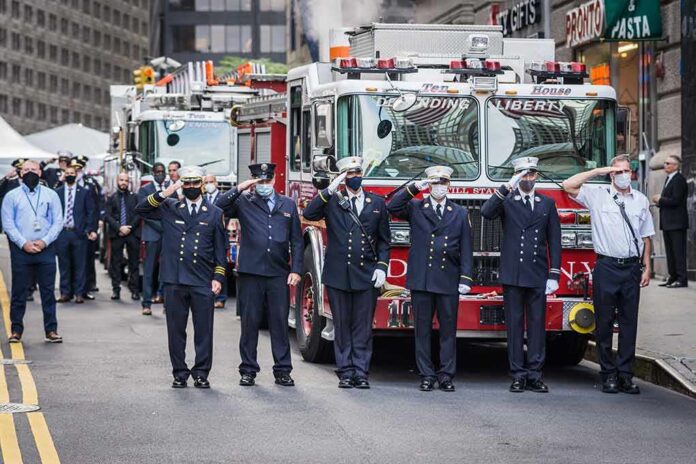 Bear Pascoe, Carlos Hyde, and Walter Jones among uniformed firefighters saluting in front of fire trucks