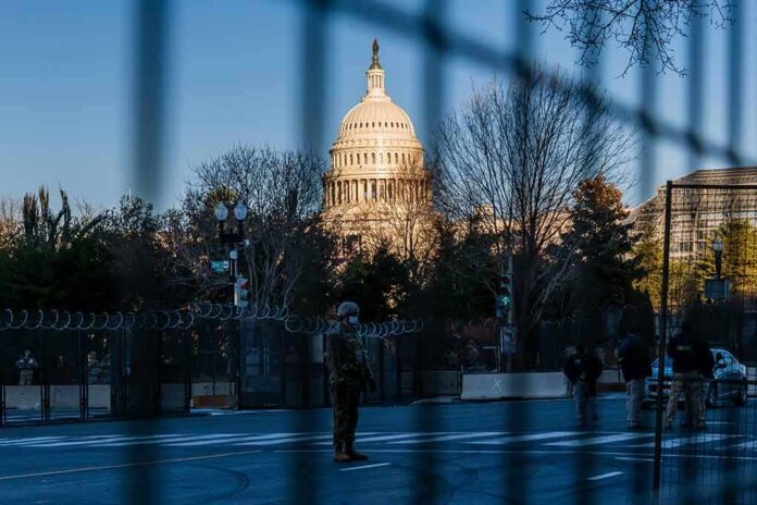shutterstock_1898228485 U.S. Capitol behind security fencing and guards on a street