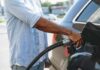 Person refueling a car at a gas pump