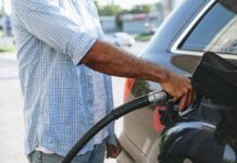 Person refueling a car at a gas pump