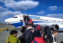 Rare Climbdown: Xi Puts Pastor On Plane Passengers boarding a commercial airplane via mobile stairs