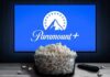 Glass bowl of popcorn in front of Paramount+ on TV