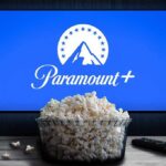 Glass bowl of popcorn in front of Paramount+ on TV