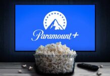 Glass bowl of popcorn in front of Paramount+ on TV