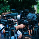 SoHo Underwater—NYC Travel Chaos TV news cameras crowding together at an outdoor event